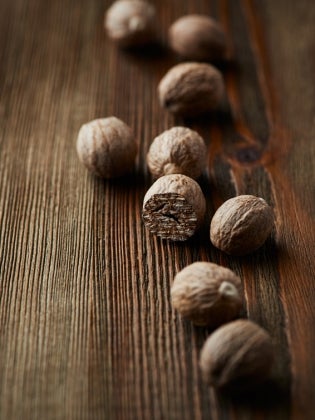 Whole nutmeg on wooden table